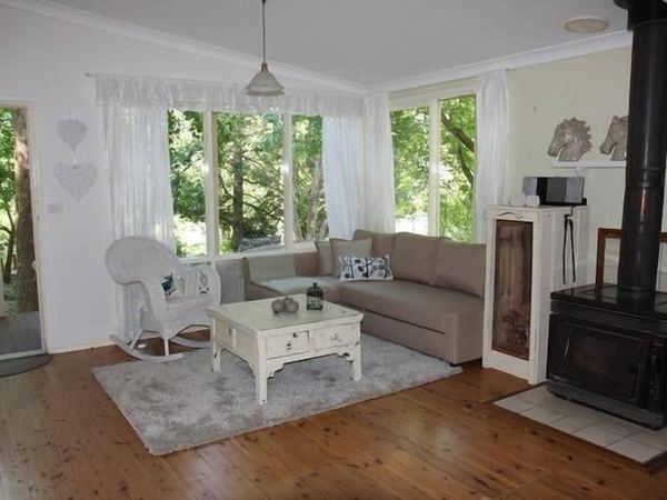 Living room with wood fire and garden views